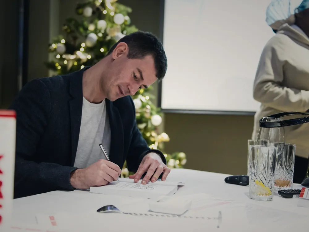 Christian Rodwell signing copies of Sack Your Boss