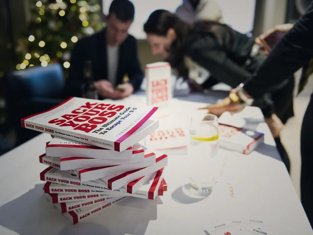 Stacks of Sack Your Boss on the signing table
