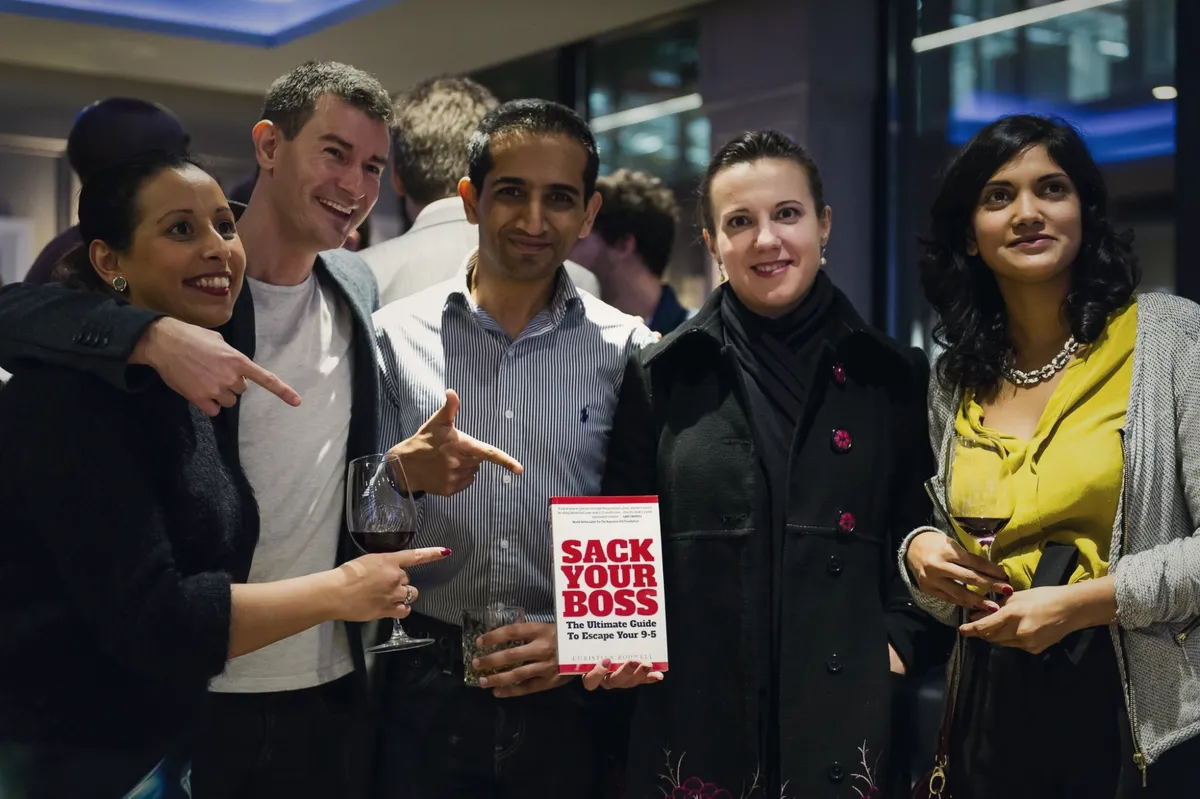 Guests at the Sack Your Boss launch holding a copy of the book